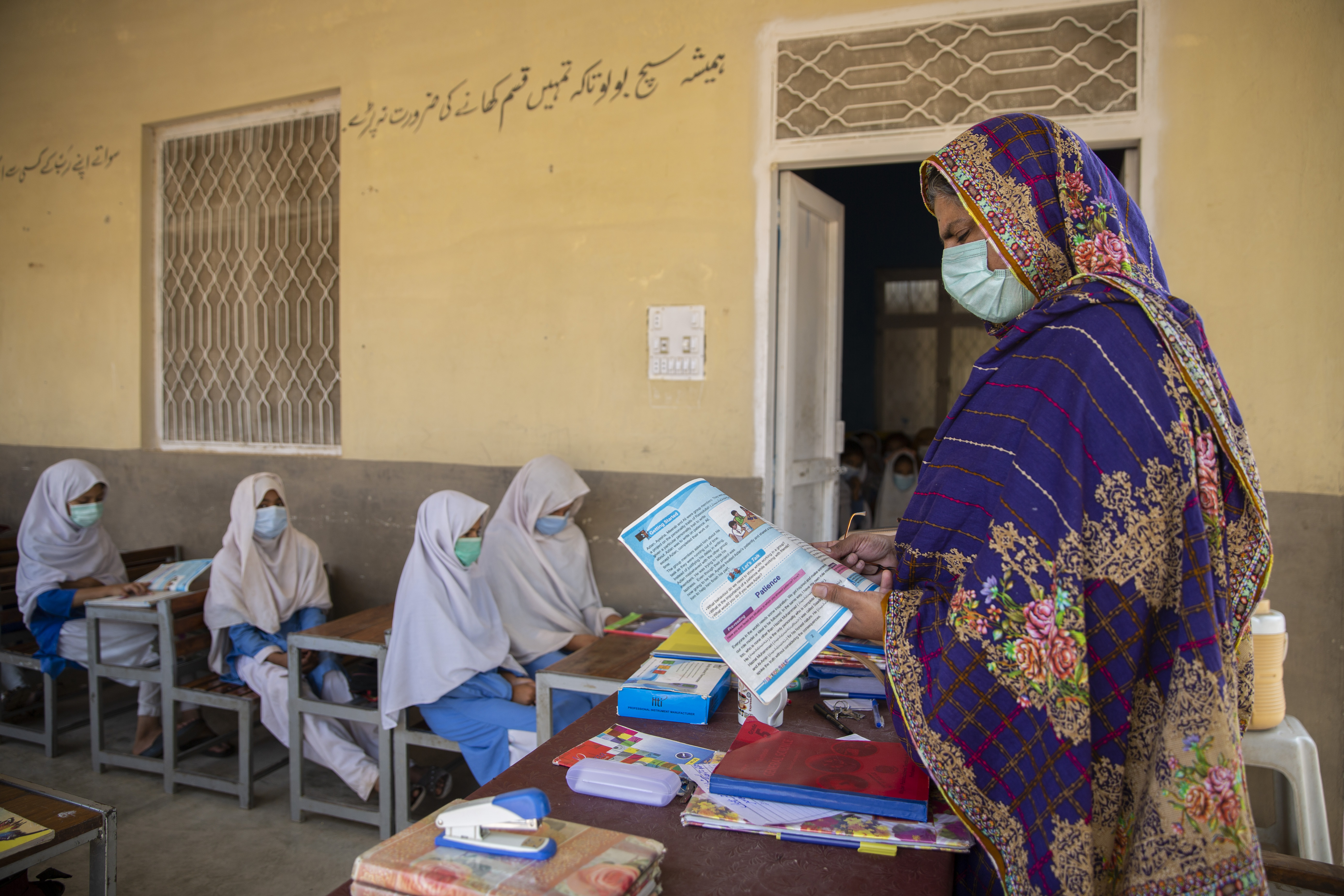 Nafeesa Ali, who is the principal of the school teaches a class of Afghan and Pakistani students at Chichana Primary School for Girls in Chichana, Kohat District, Pakistan